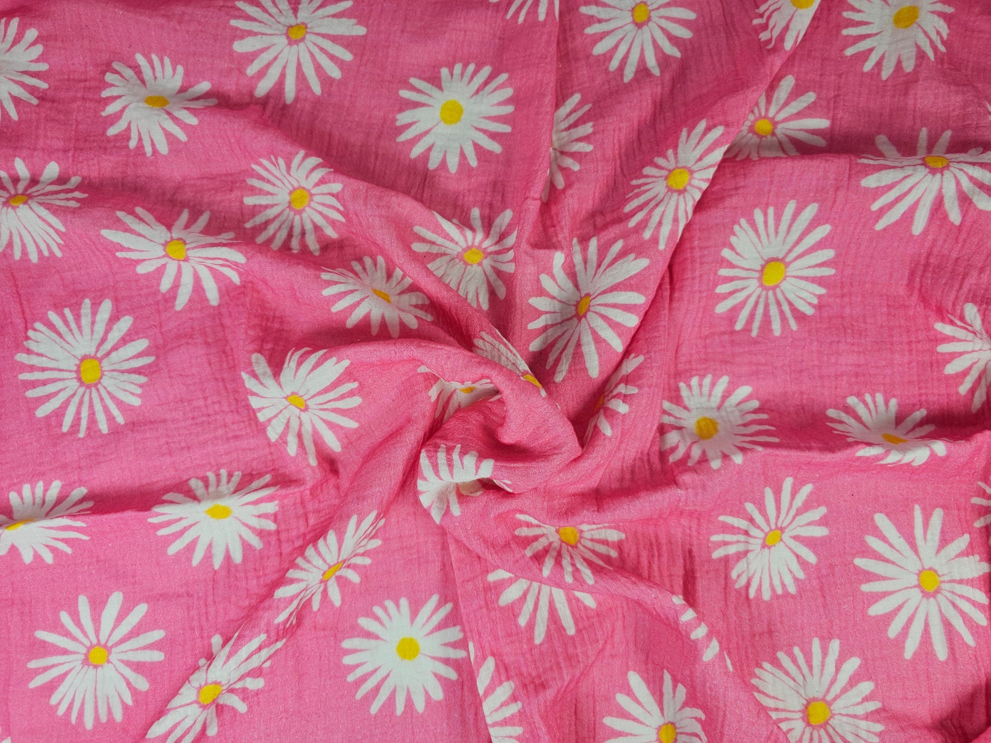 Pink cotton fabric with a white daisy floral print on double gauze fabric
