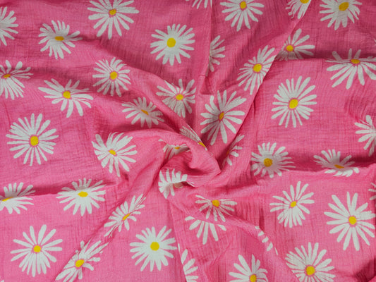 Pink cotton fabric with a white daisy floral print on double gauze fabric