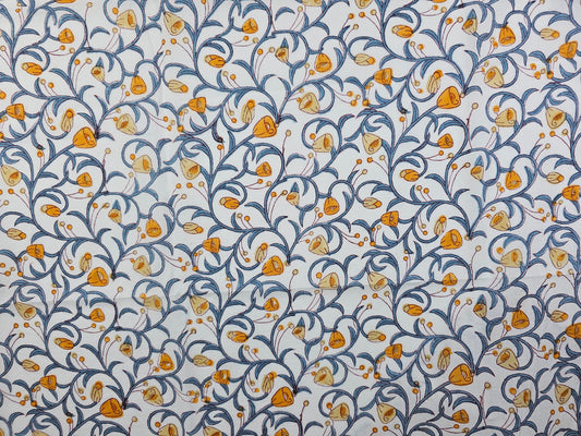 A hand printed floral pattern featuring orange and yellow flowers with blue scrolling vines on a white background.